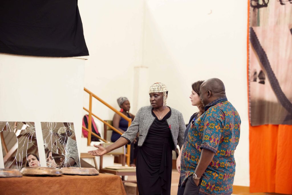 Curator Kazungu Martha, Dr. Nabulime Lilian and Guest of Honour Triza Musoke in blue (Left to Right) have a chat during the exhibition.
